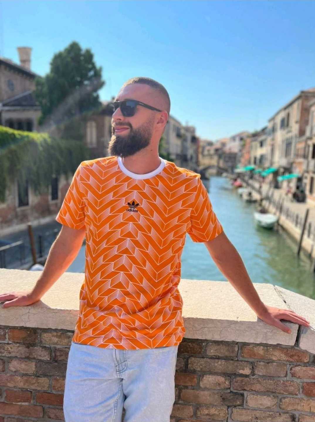 Rares Francu wearing an orange shirt in venice (maybe)