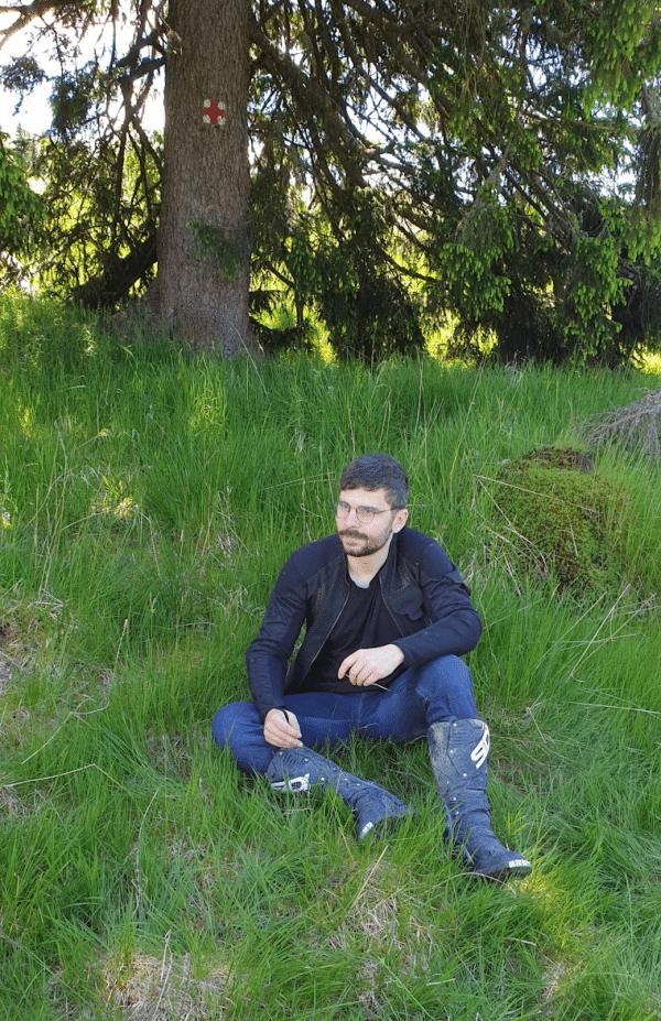 Tibi, smrtPhone's Front End Developer, sitting on a grass